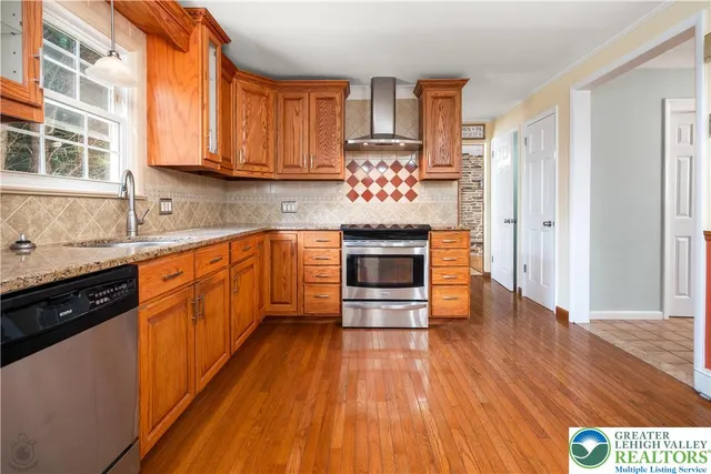 a kitchen with stainless steel appliances a stove top oven and a refrigerator
