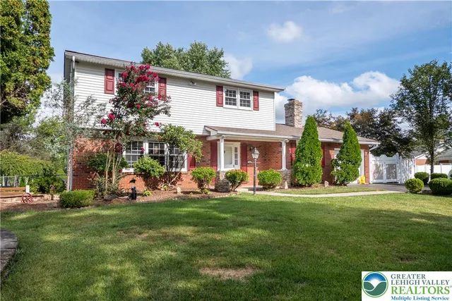 a front view of house with yard outdoor seating and green space