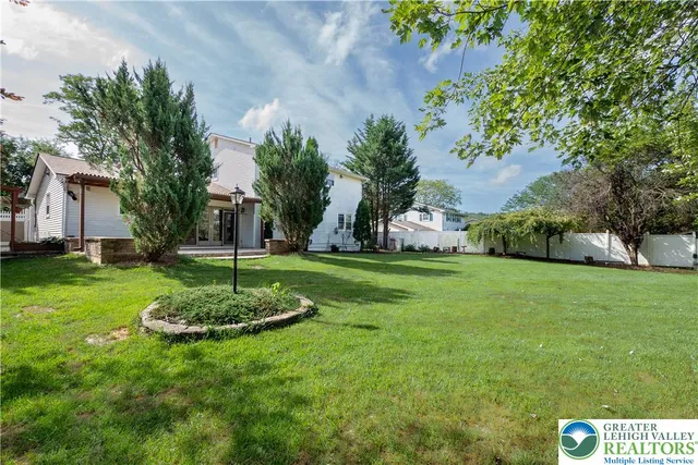 a swimming pool with trees in the background