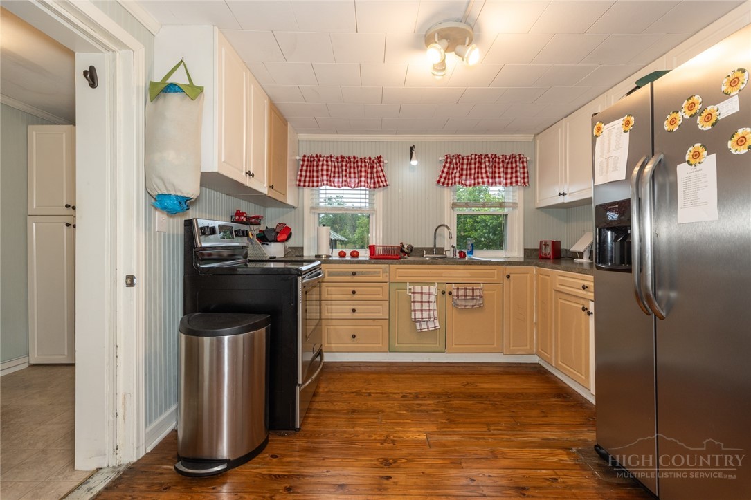 1335 Shingle Gap Road Purlear, NC 28665 - Photo 41 of 49 a kitchen with stainless steel appliances a stove refrigerator sink and microwave