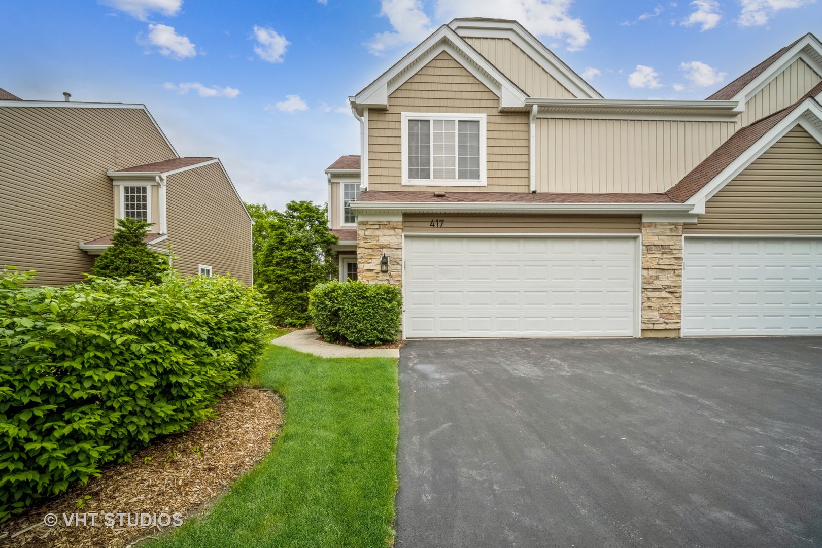 a front view of a house with a yard and garage