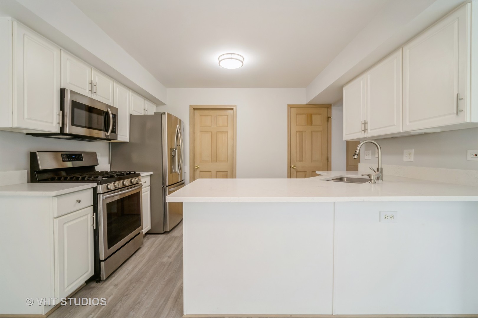 417 Locksley Drive Streamwood, IL 60107 - Photo 11 of 25 a kitchen with stainless steel appliances a stove microwave and sink