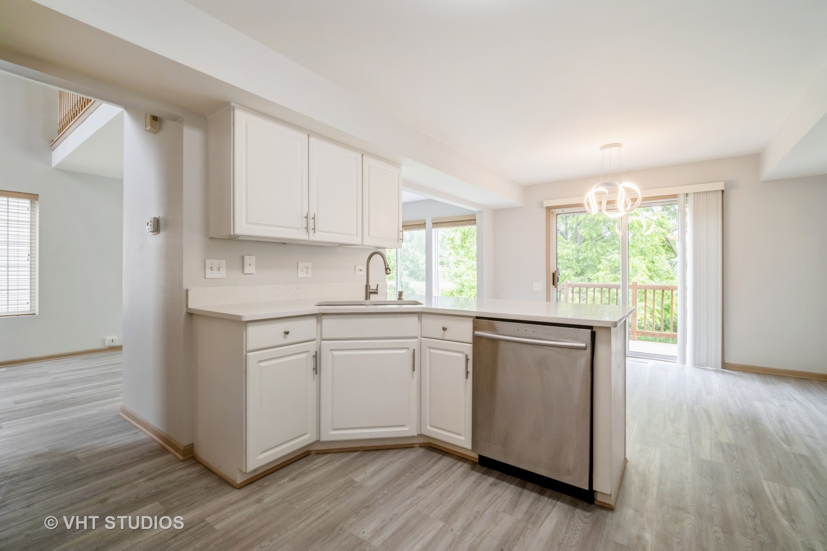 417 Locksley Drive Streamwood, IL 60107 - Photo 12 of 25 a kitchen with stainless steel appliances granite countertop a stove a sink dishwasher and white cabinets with wooden floor