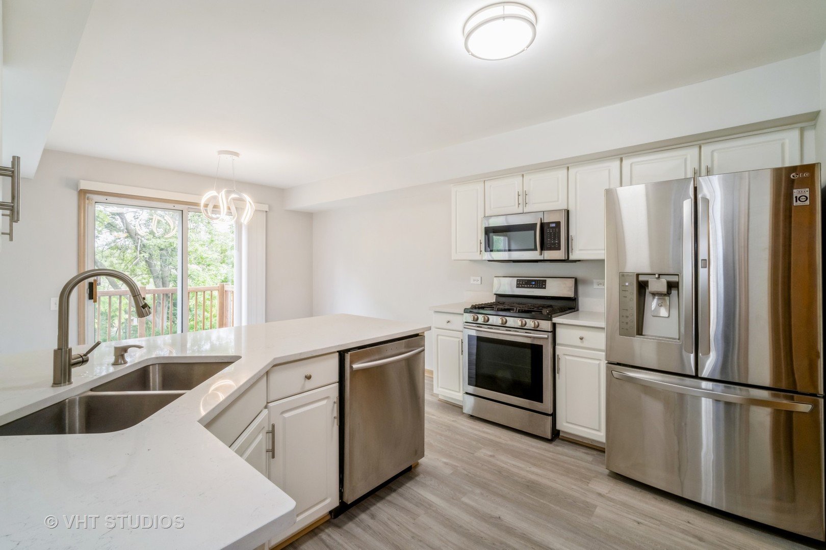 417 Locksley Drive Streamwood, IL 60107 - Photo 13 of 25 a kitchen with a refrigerator sink and wooden floor