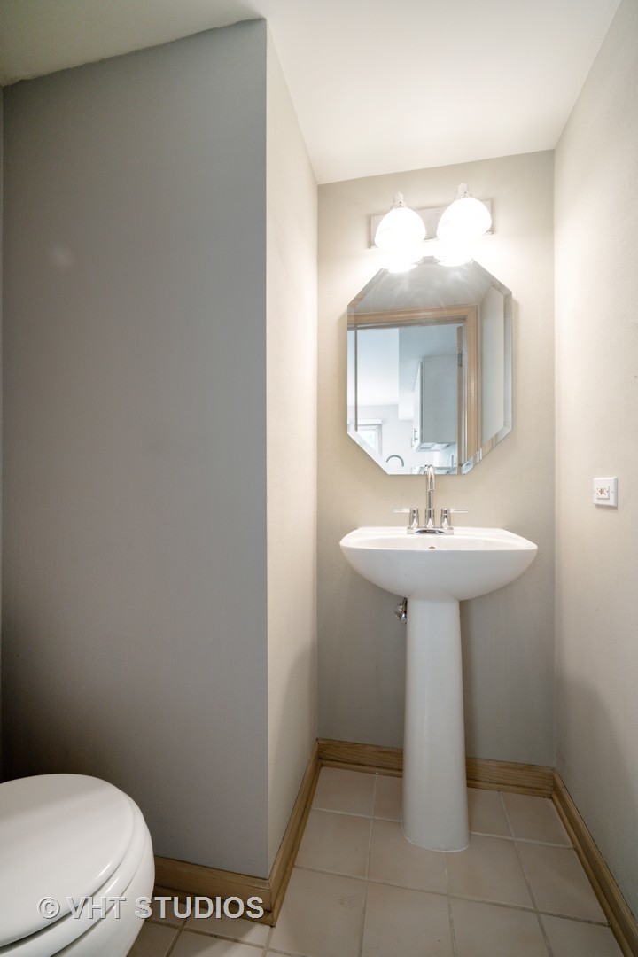 417 Locksley Drive Streamwood, IL 60107 - Photo 15 of 25 a bathroom with a sink a mirror and toilet