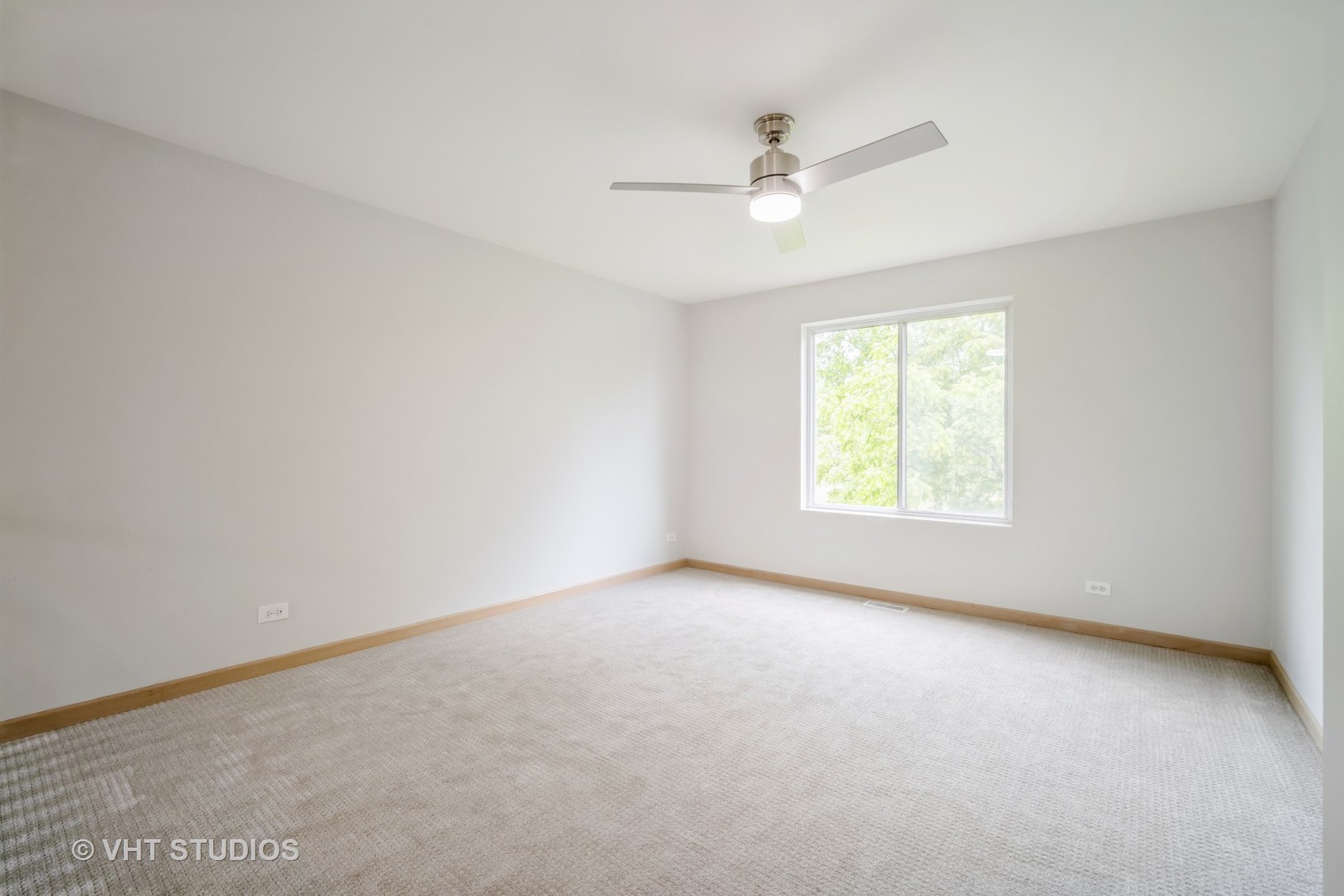 417 Locksley Drive Streamwood, IL 60107 - Photo 17 of 25 an empty room with a window and a fan