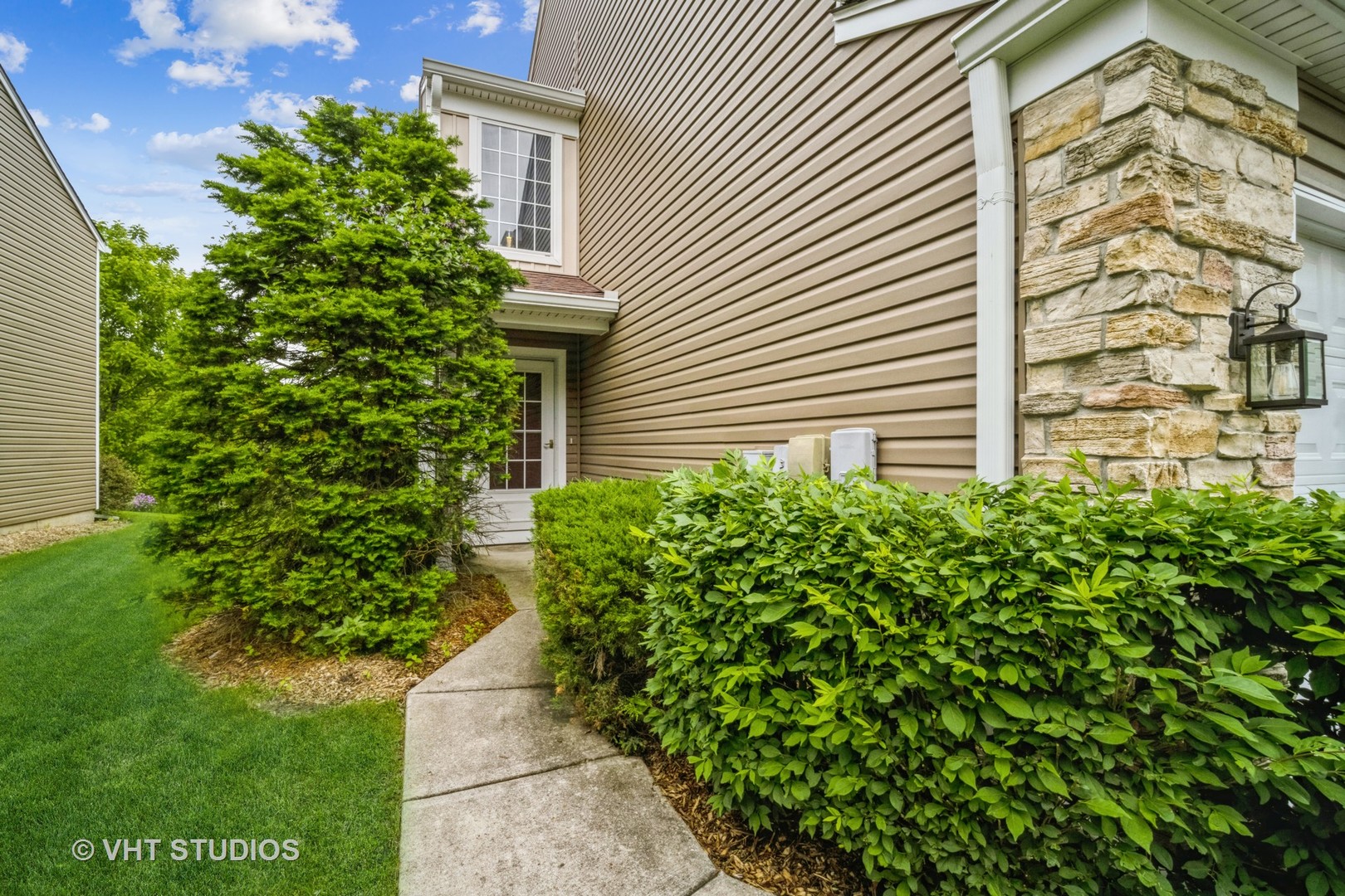 417 Locksley Drive Streamwood, IL 60107 - Photo 3 of 25 a pathway of a house with potted plants