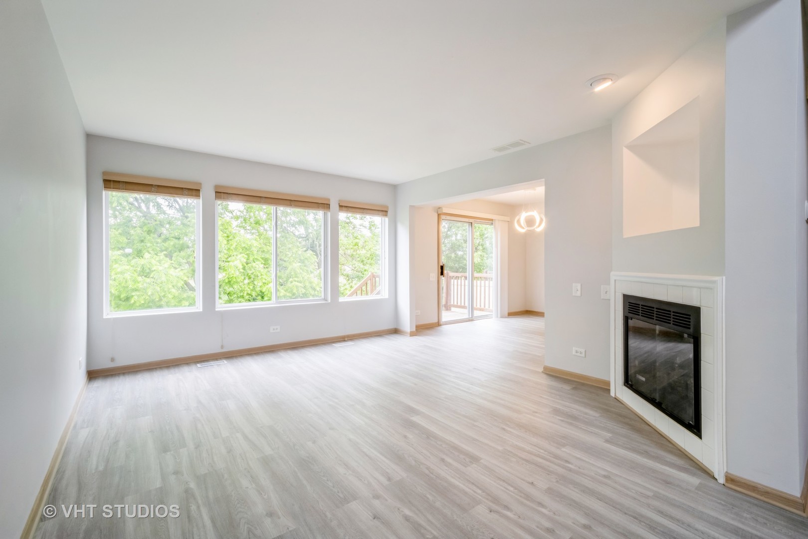 417 Locksley Drive Streamwood, IL 60107 - Photo 8 of 25 wooden floor fireplace and windows in an empty room