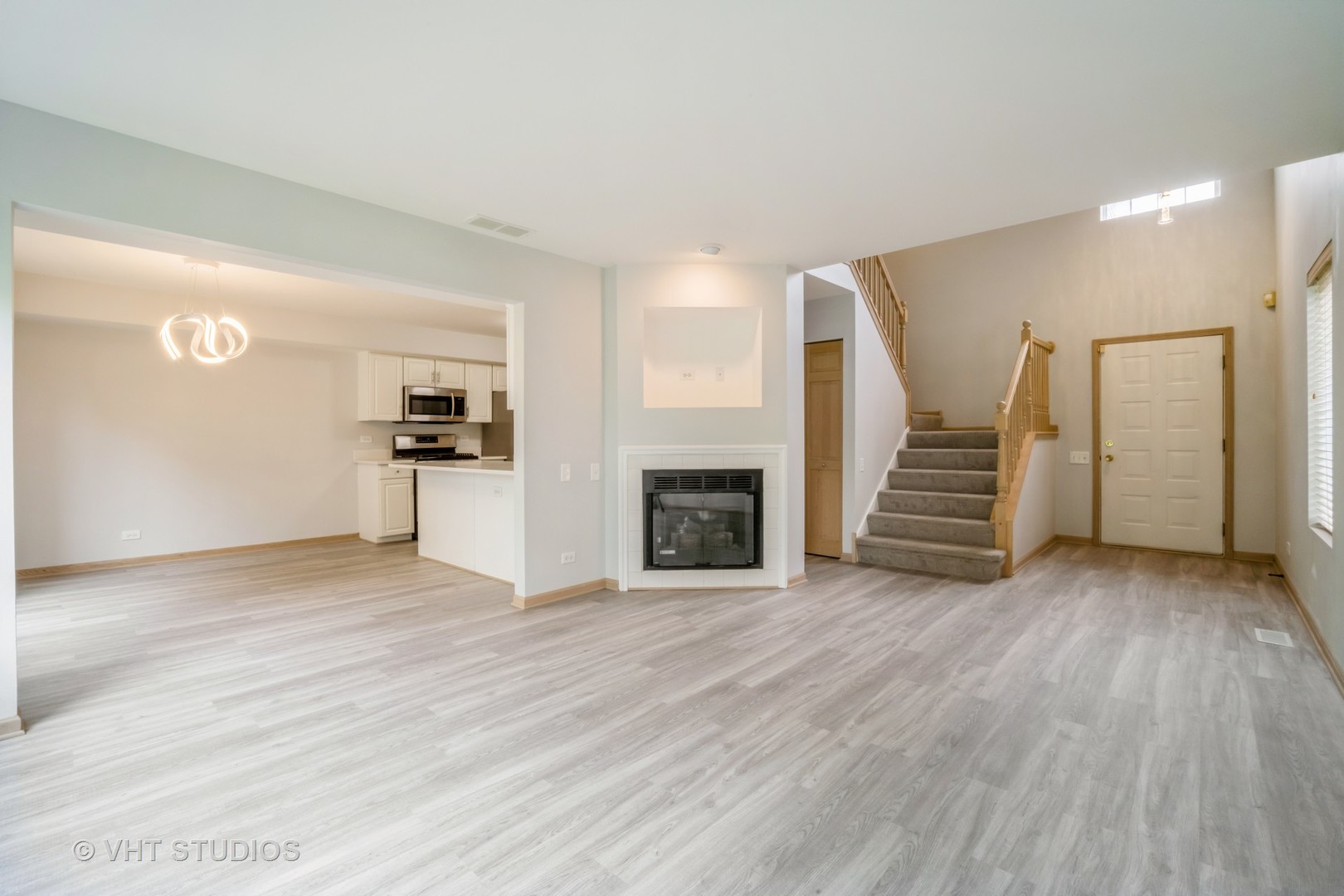 417 Locksley Drive Streamwood, IL 60107 - Photo 9 of 25 a view of a livingroom with wooden floor and staircase