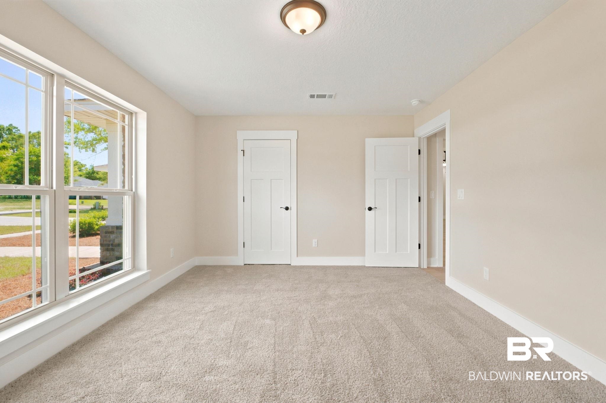 32656 Arbor Ridge Circle Lillian, AL 36549 - Photo 22 of 56 Neutral-toned room featuring a large window with multiple panes and white trim