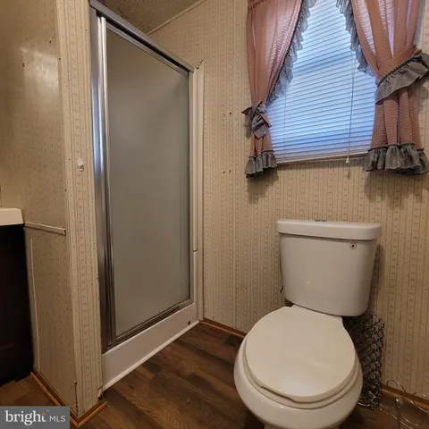 a white toilet sitting next to a bathroom sink