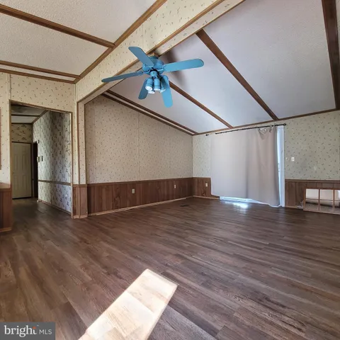 a view of a big room with wooden floor and staircase