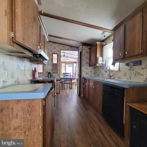 a kitchen with lots of counter top space and wooden floor