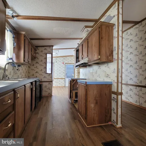 a kitchen with wooden cabinets and a sink