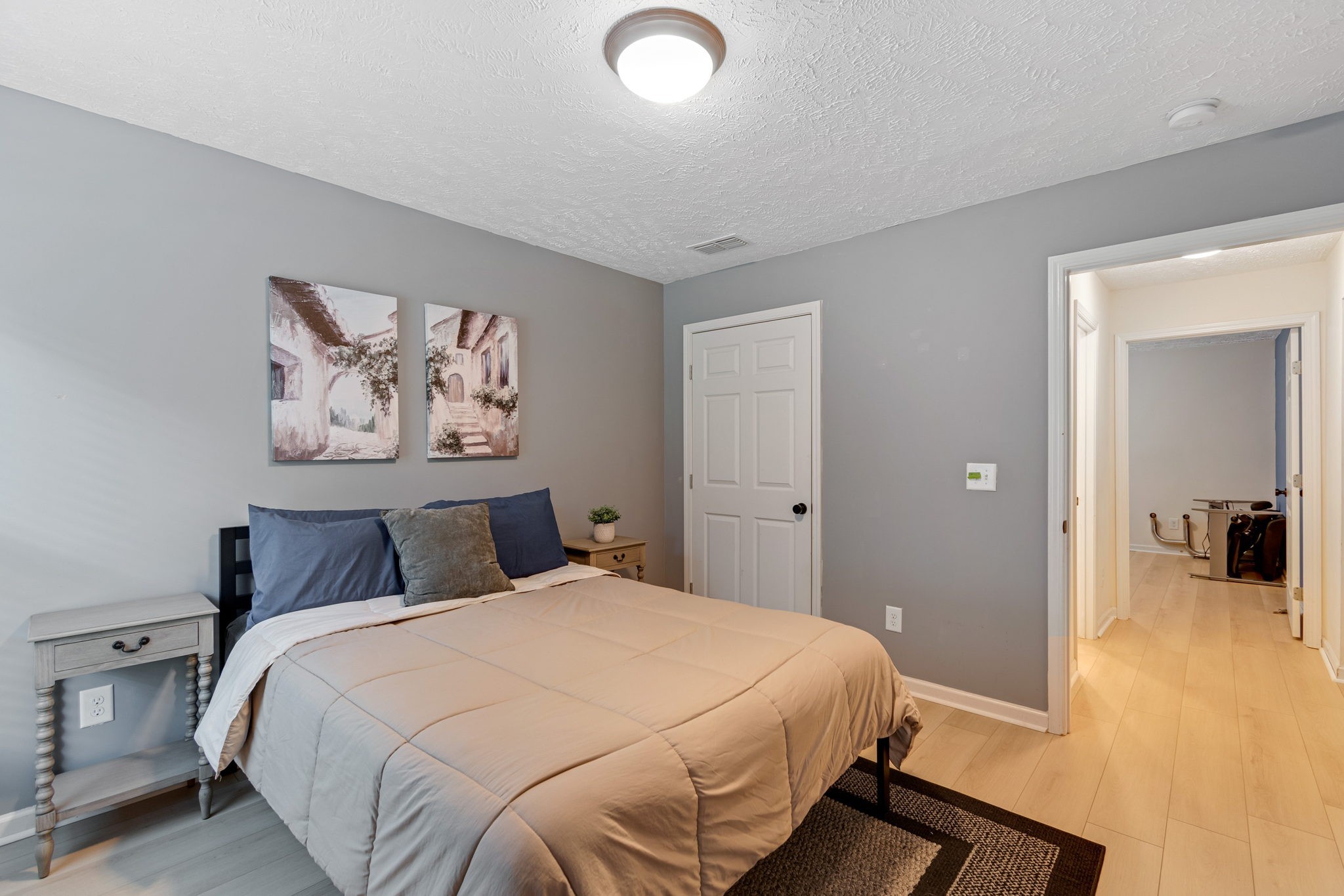 6045 Cane Springs Road Antioch, TN 37013 - Photo 13 of 23 a bedroom with a large bed and a chandelier