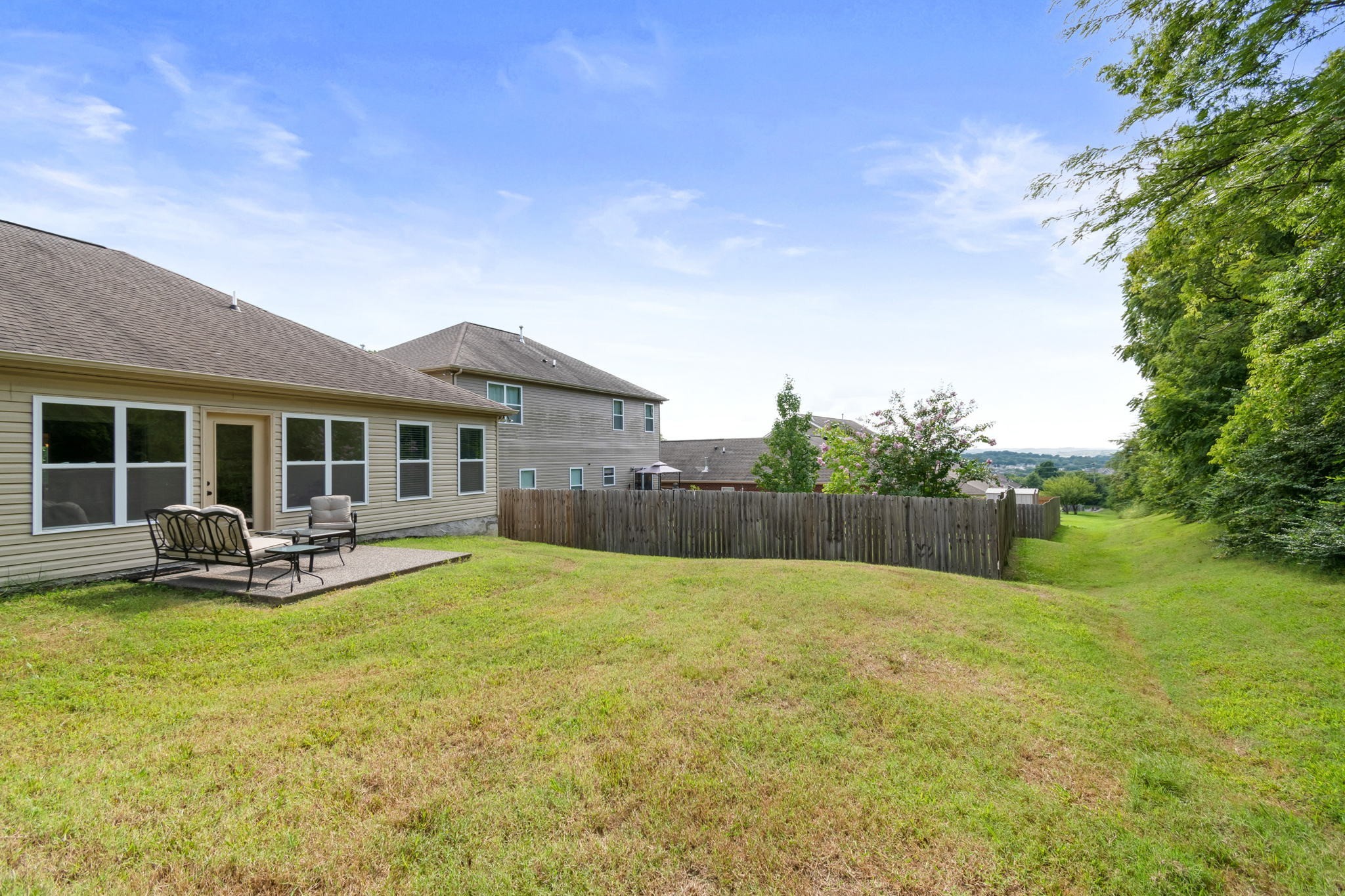 6045 Cane Springs Road Antioch, TN 37013 - Photo 19 of 23 a view of a house with a backyard and a patio