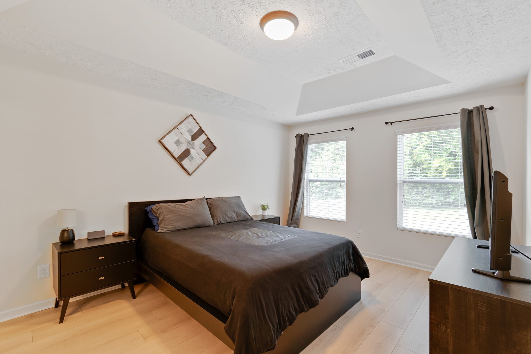 6045 Cane Springs Road Antioch, TN 37013 - Photo 8 of 23 a bedroom with a bed and a flat screen tv