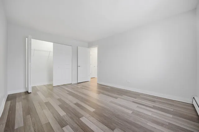 a view of an empty room and wooden floor