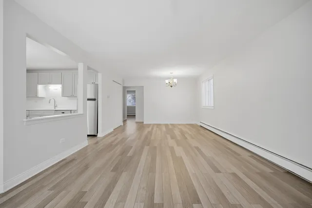 a view of a kitchen with wooden floor and a sink