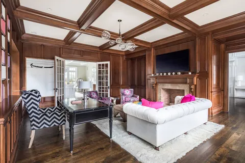 a living room with furniture and a ceiling fan