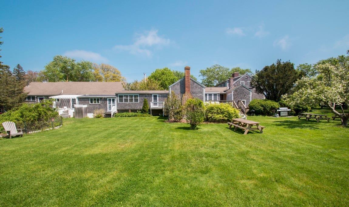 545 Old Harbor Road Chatham, MA 02633 - Photo 1 of 35 a view of a house with backyard and sitting area