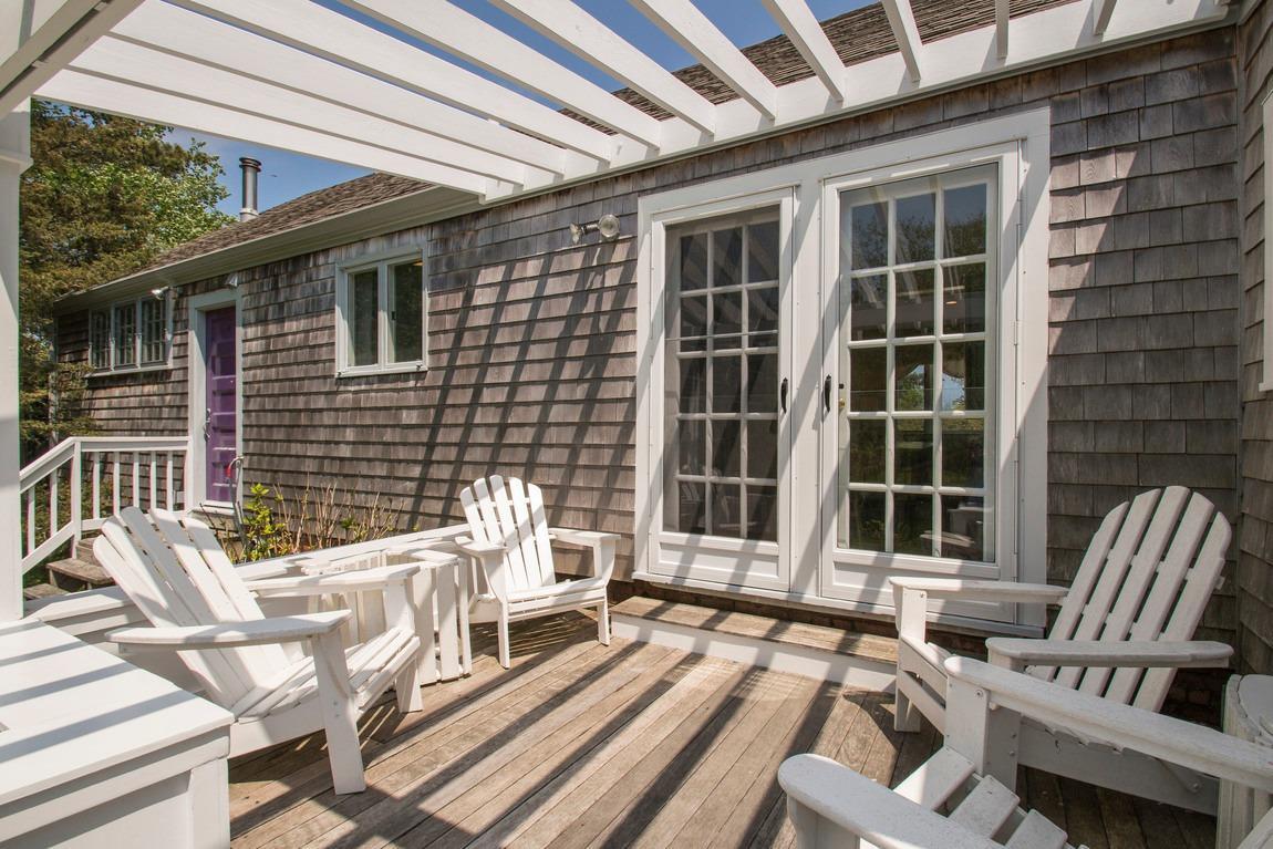 545 Old Harbor Road Chatham, MA 02633 - Photo 14 of 35 a view of a patio with couple of chairs