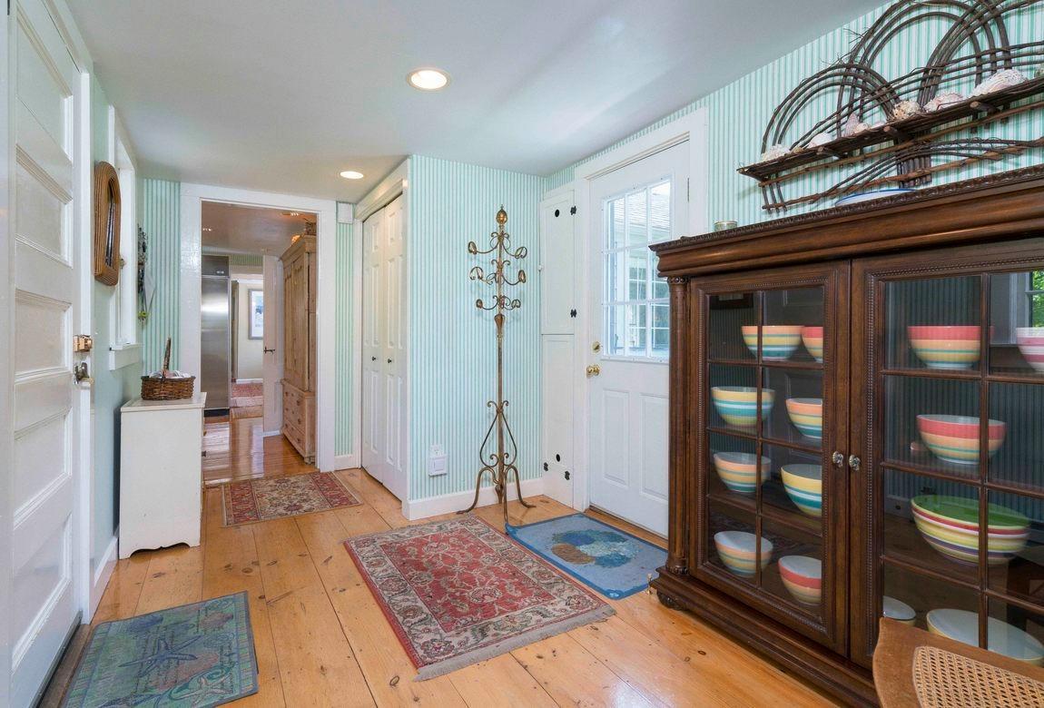 545 Old Harbor Road Chatham, MA 02633 - Photo 15 of 35 a view of a hallway with wooden floor and a living room