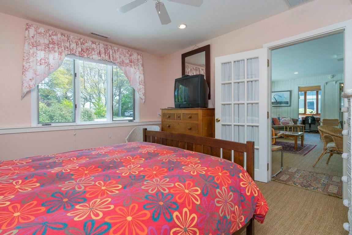 545 Old Harbor Road Chatham, MA 02633 - Photo 16 of 35 a bedroom with a bed and large windows