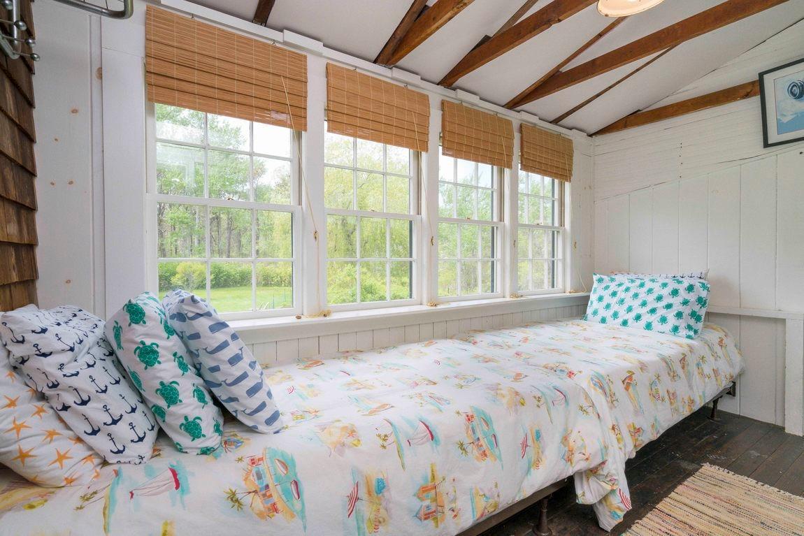 545 Old Harbor Road Chatham, MA 02633 - Photo 21 of 35 a bedroom with a bed and a large window