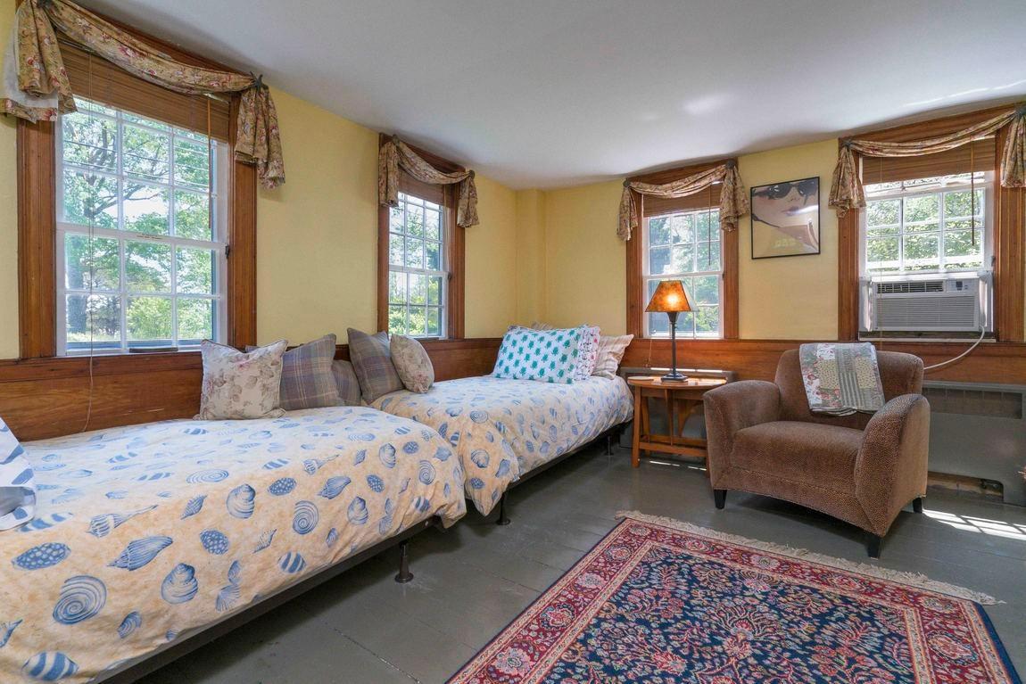 545 Old Harbor Road Chatham, MA 02633 - Photo 25 of 35 a bedroom with two beds and a couch next to a window