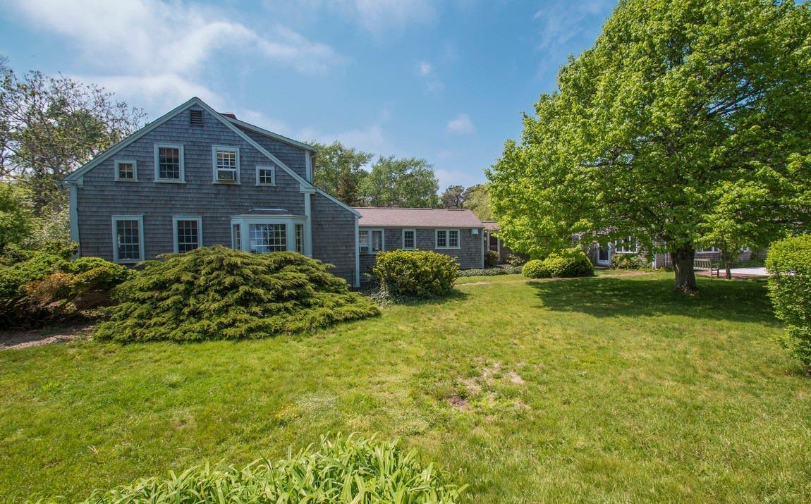 545 Old Harbor Road Chatham, MA 02633 - Photo 3 of 35 a front view of house with yard and trees