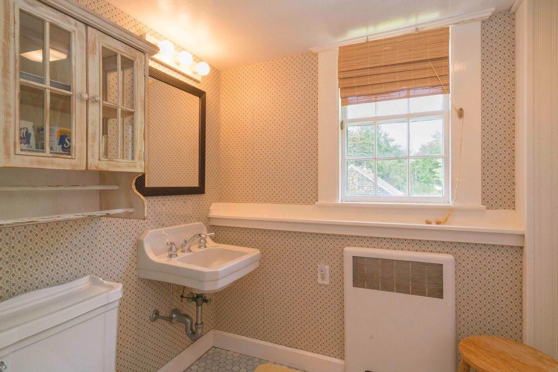 545 Old Harbor Road Chatham, MA 02633 - Photo 32 of 35 a bathroom with a sink a toilet and a mirror