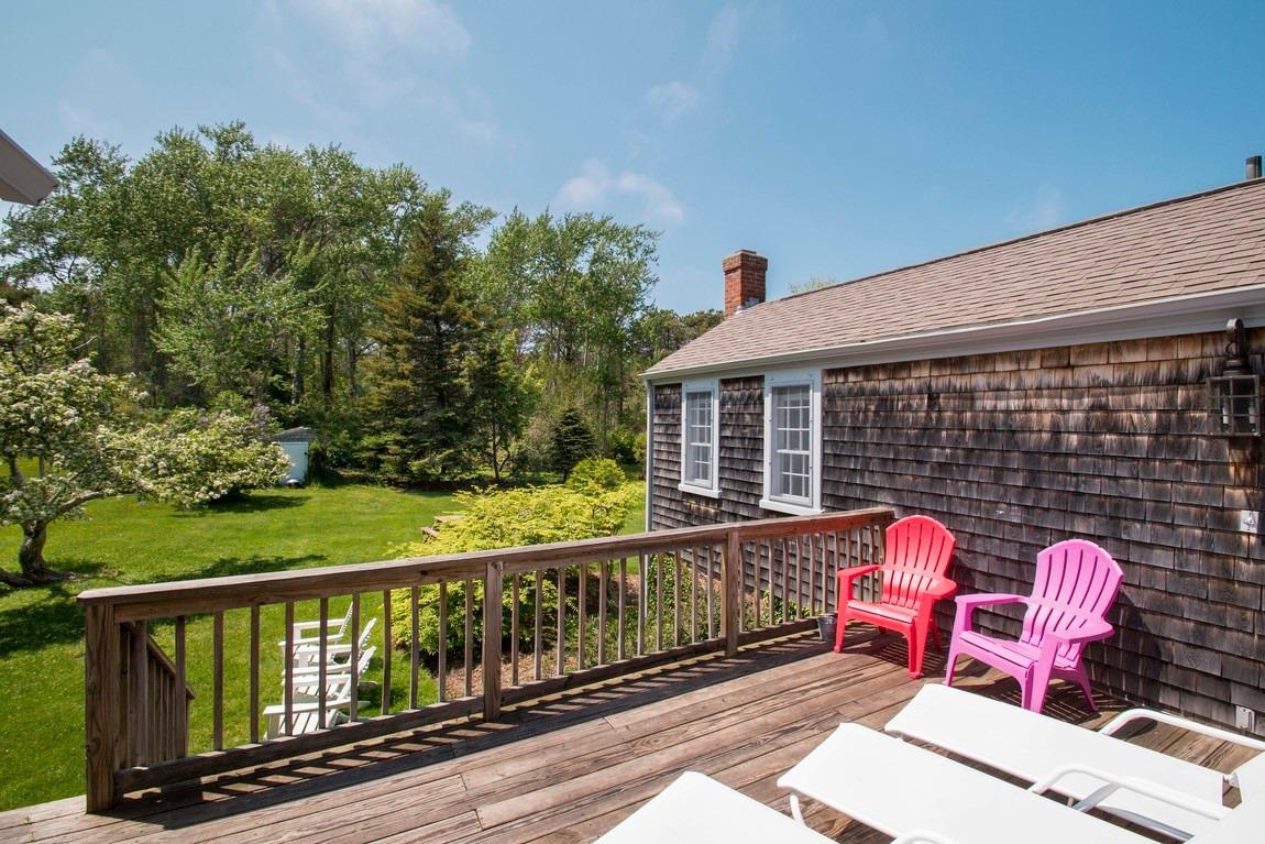 545 Old Harbor Road Chatham, MA 02633 - Photo 8 of 35 a view of a deck with wooden floor and outdoor seating