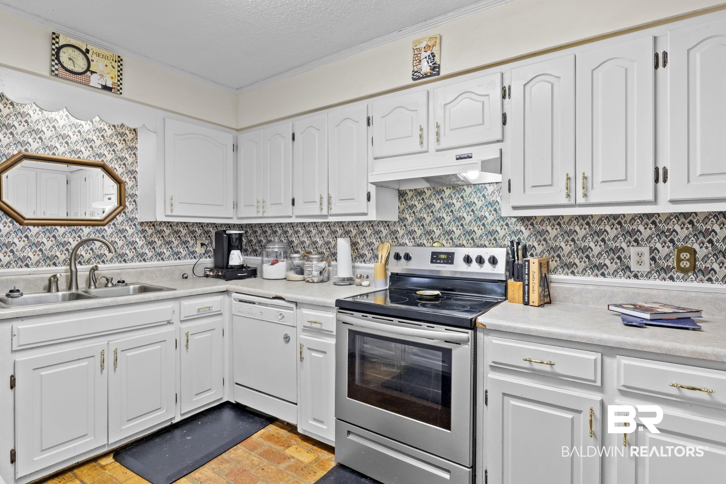 8701 A Rosemary Road Eight Mile, AL 36613 - Photo 10 of 27 Kitchen with dishwasher, white cabinetry, premium range hood, sink, and stainless steel range with electric cooktop