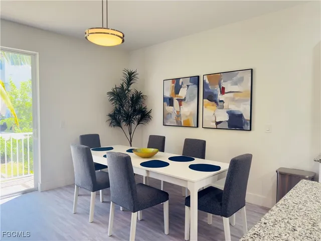 a kitchen with granite countertop a sink white cabinets and stainless steel appliances
