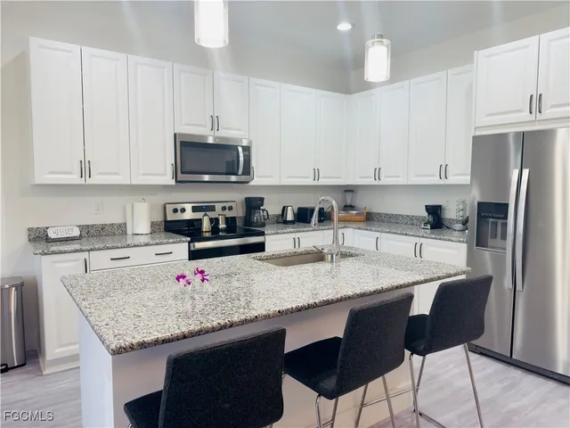 a room with a microwave a sink and a microwave