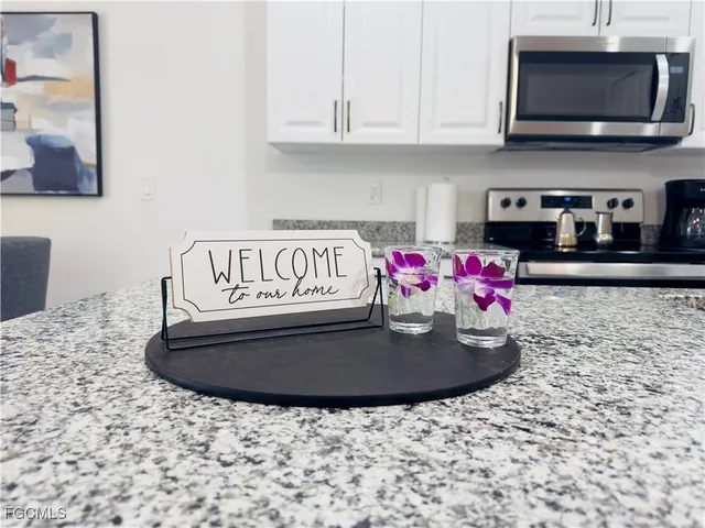 a kitchen with granite countertop a sink and a white stove