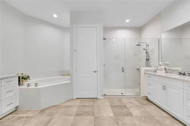 a bathroom with a tub a sink shower and mirror