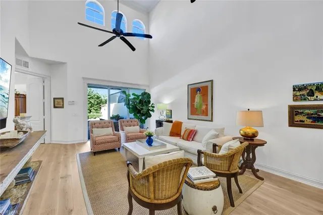 a living room with furniture a rug and a large window
