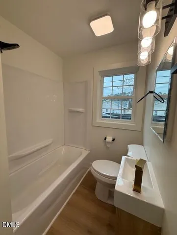 a bathroom with a toilet a sink and a bathtub
