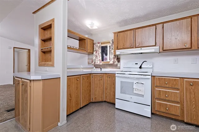 a kitchen with granite countertop cabinets and window