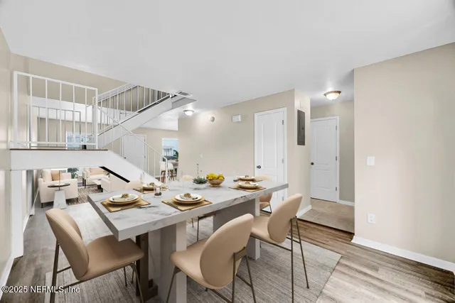 a view of a dining room with furniture and wooden floor