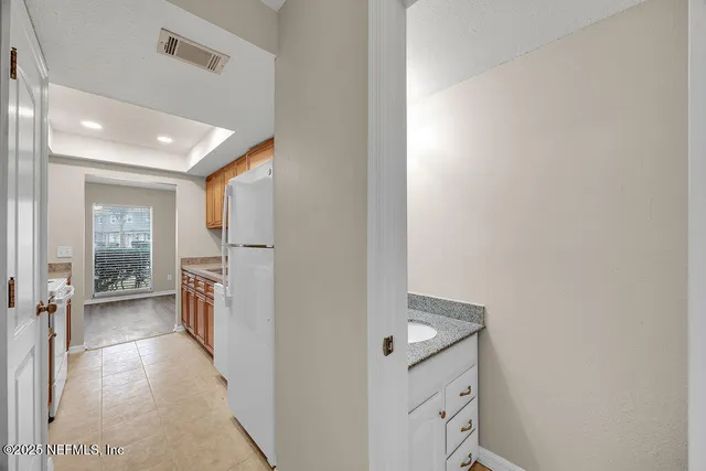 a view of a hallway with a kitchen