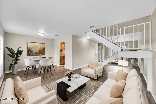 a living room with furniture and wooden floor