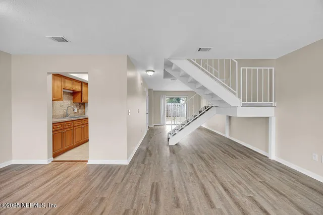 a view of entryway and hall with wooden floor