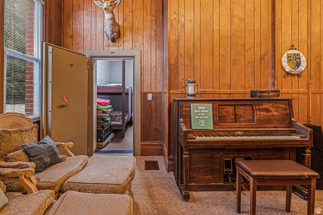 21 North Main Street Kingston, UT 84743 - Photo 31 of 107 Sitting room featuring wooden walls and carpet floors