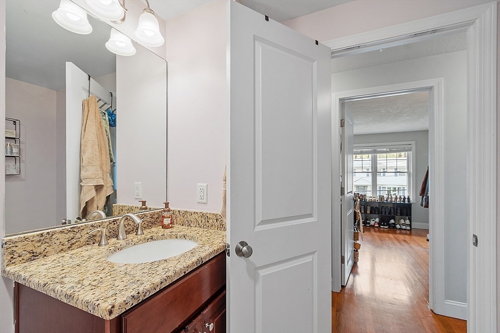 26 Pondover Road, Unit 26 Billerica, MA 01821 - Photo 16 of 23 a bathroom with a granite countertop sink and a mirror