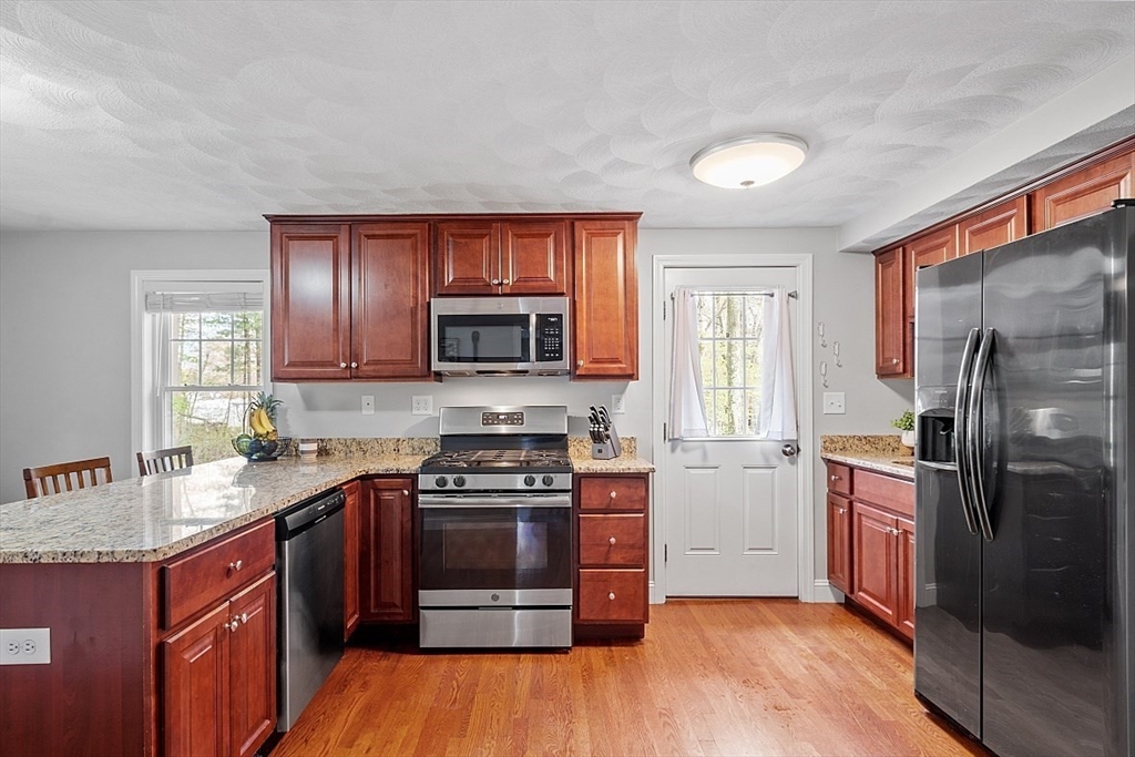 26 Pondover Road, Unit 26 Billerica, MA 01821 - Photo 3 of 23 a kitchen with a stove a sink and a microwave