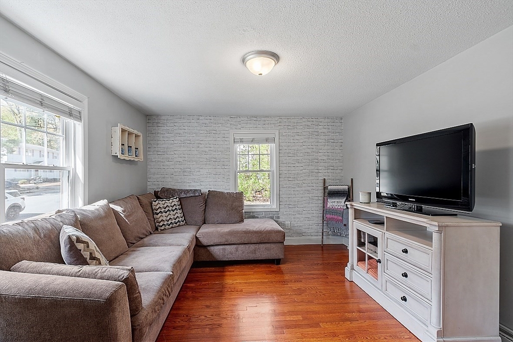 26 Pondover Road, Unit 26 Billerica, MA 01821 - Photo 6 of 23 a living room with furniture and a flat screen tv