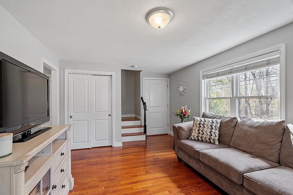 26 Pondover Road, Unit 26 Billerica, MA 01821 - Photo 7 of 23 a living room with furniture and a flat screen tv